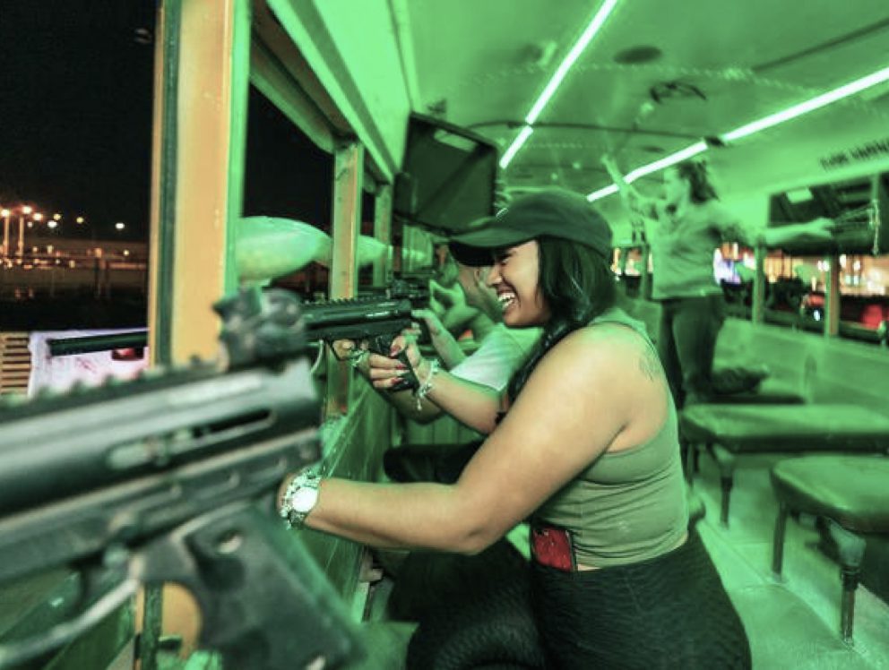 woman firing paintball gun at zombie rampage event